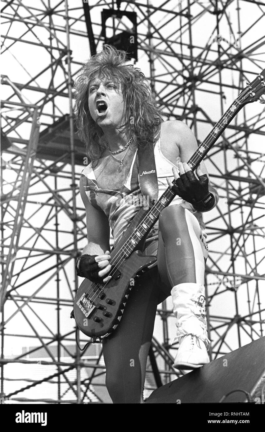 Bassist Jeff Pilson is shown performing on stage during a 'live' concert appearance with Dokken. Stock Photo