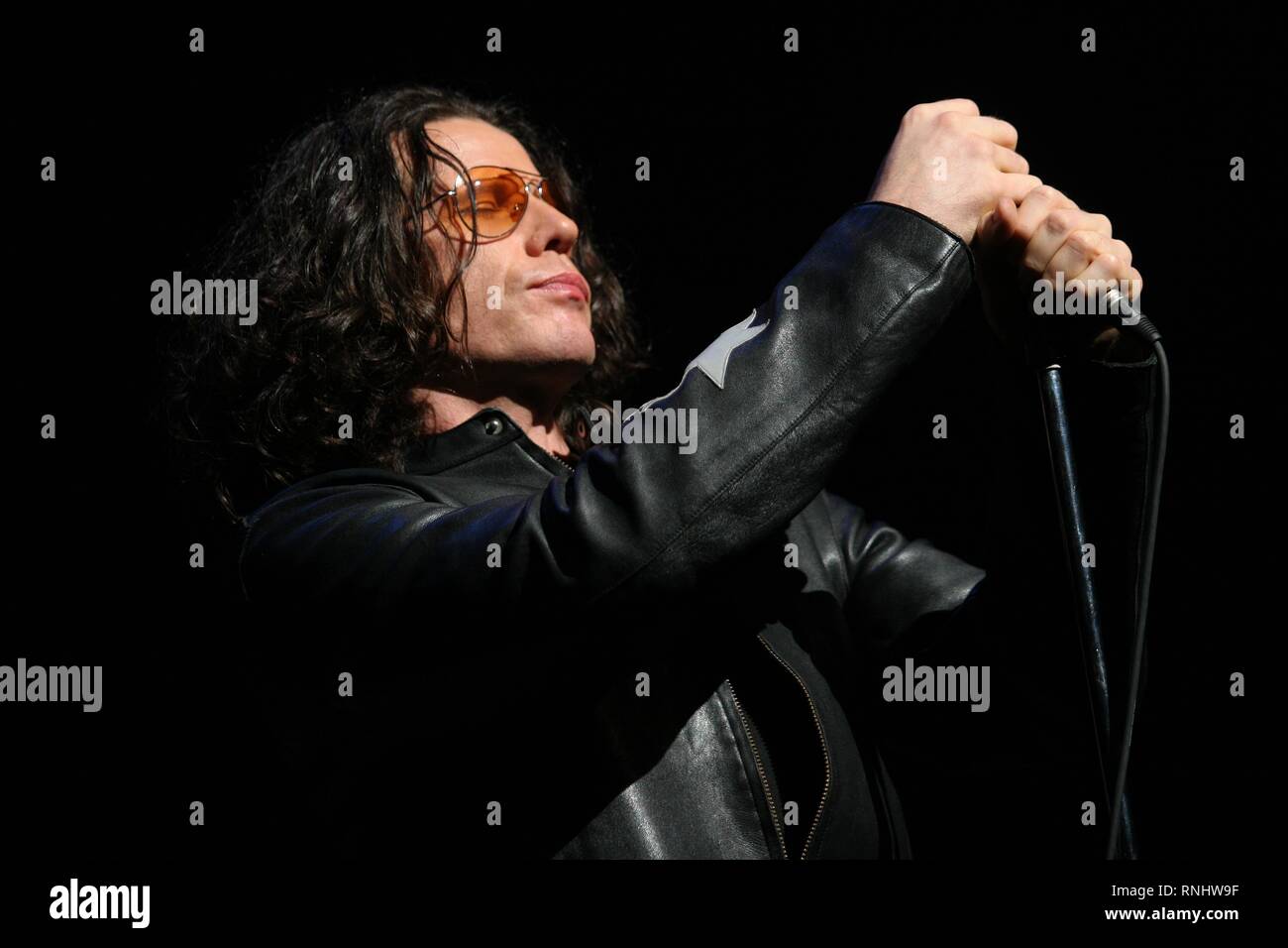 Singer Ian Astbury of The Doors is shown performing on stage during a 'live' concert appearance. Stock Photo