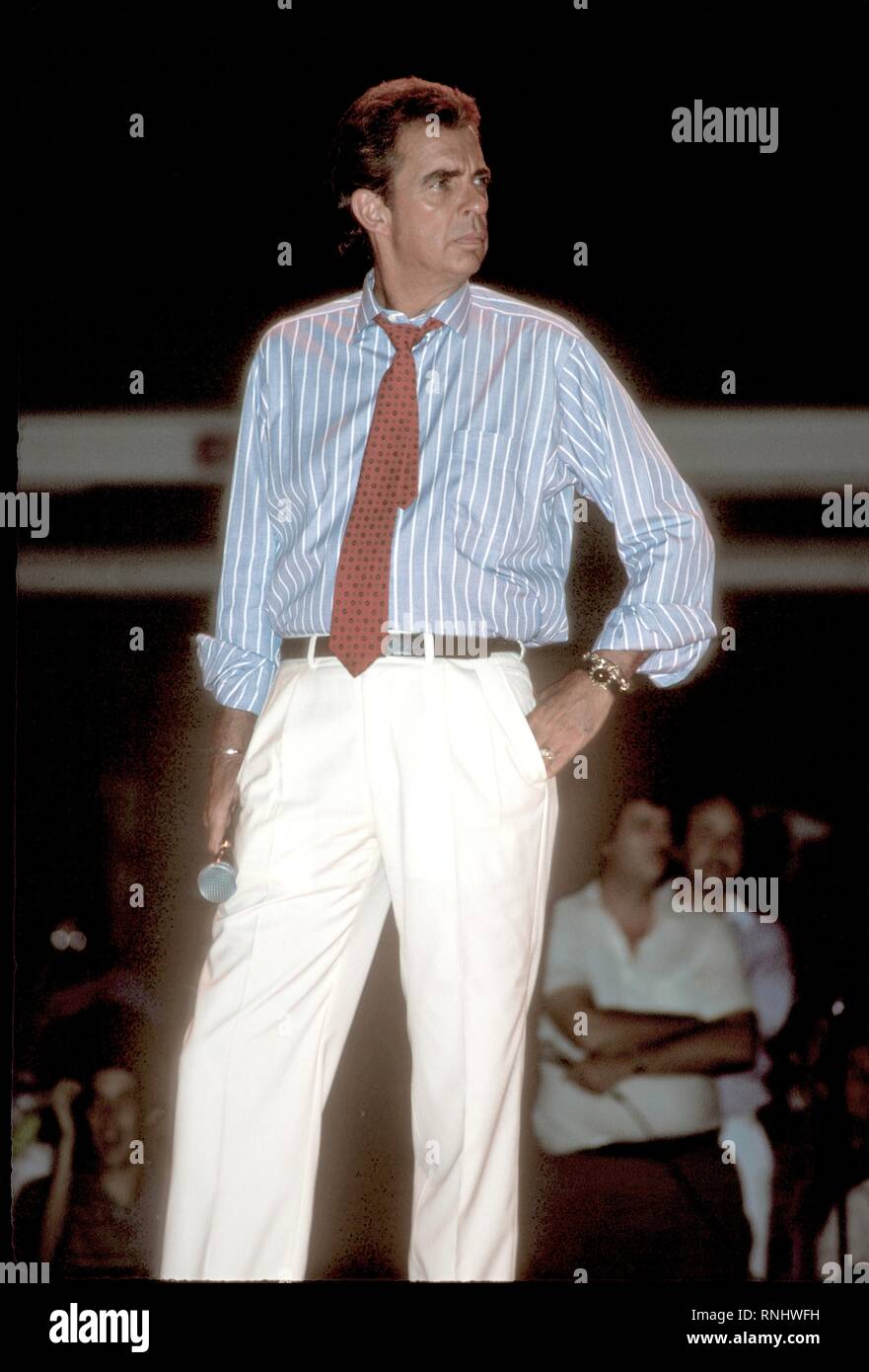 Television talk show host of the 1980s who pioneered the 'trash TV' format, Morton Downey Jr, is shown on stage during a concert appearance. Stock Photo