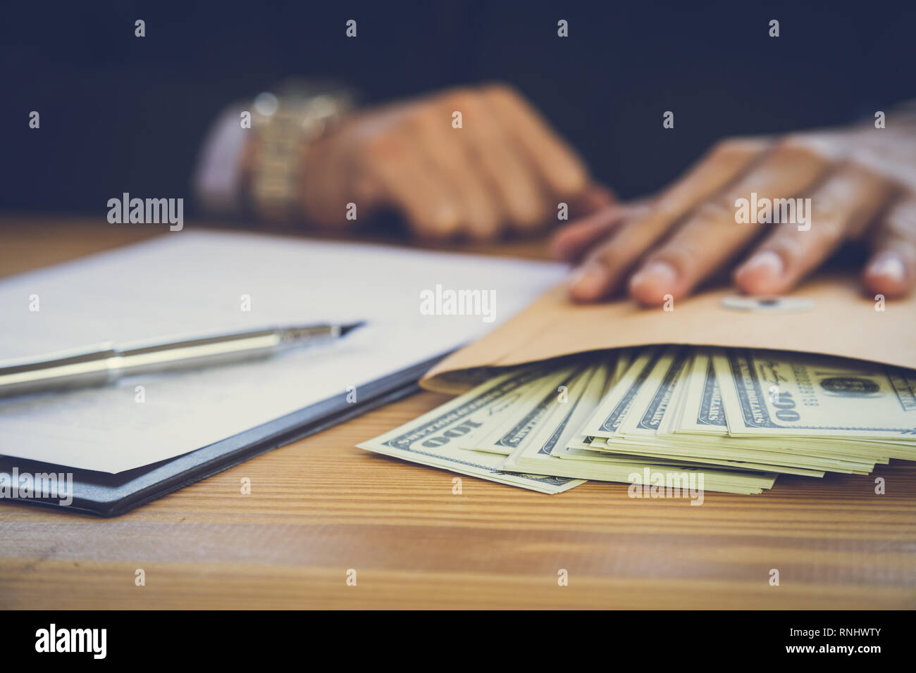 Business man signing a contract. Owns the business sign personally, director of the company, solicitor. Real estate agent holding house, financial or  Stock Photo