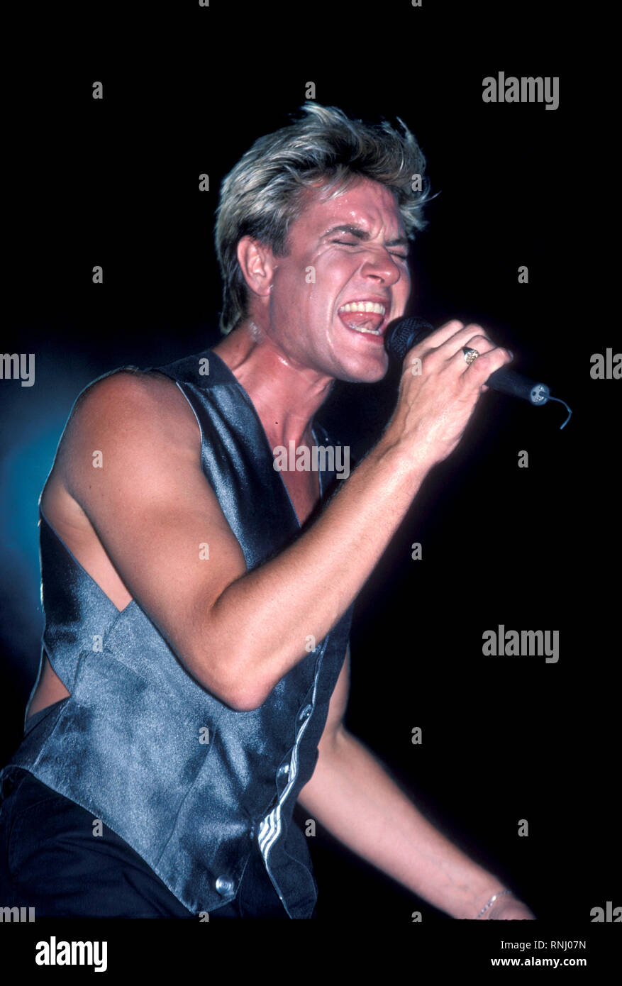 Duran Duran singer Simon LeBon is shown performing on stage during a 'live' concert appearance. Stock Photo