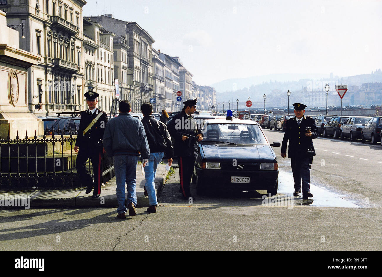 Italian police inspect a car on a street in Florence Italy 