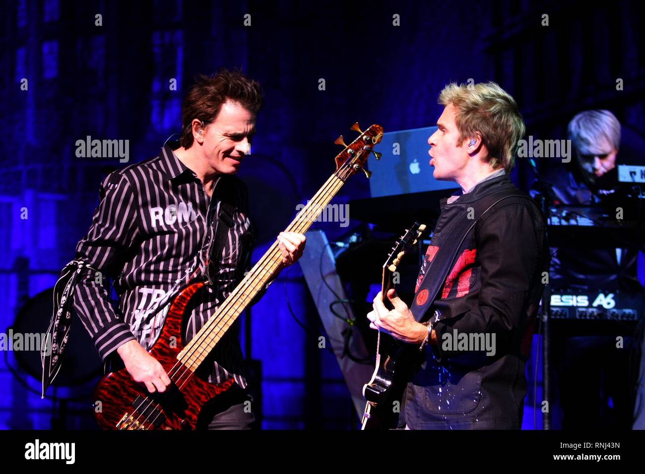 Duran Duran band members are shown performing on stage during a 'live' concert appearance. Stock Photo