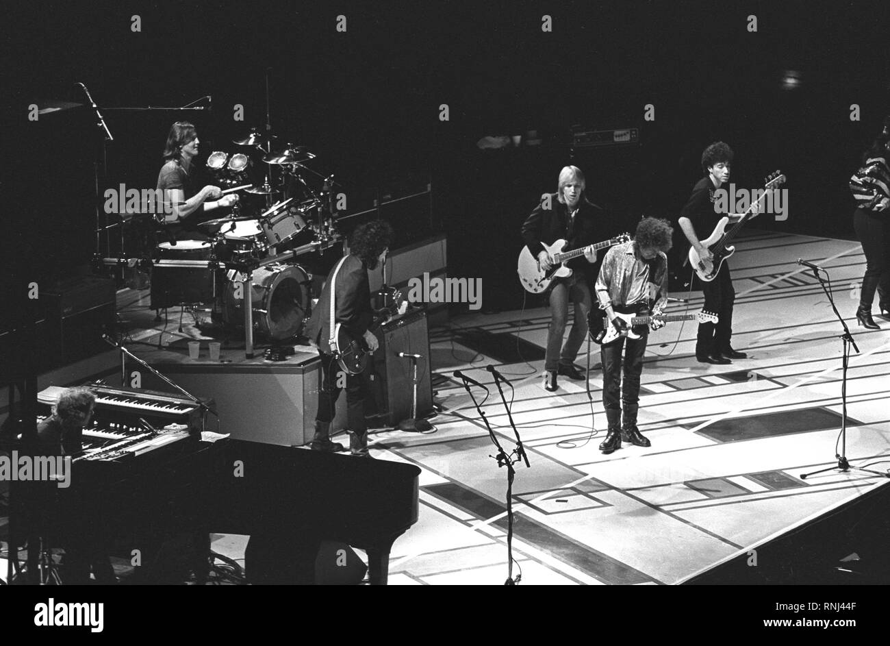 Musician Bob Dylan is shown performing along with Tom Petty during a 'live' concert appearance. Stock Photo