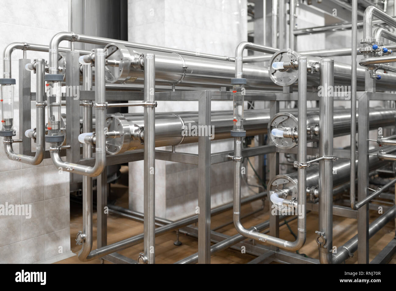 Chrome pipes close-up. Industrial background Stock Photo - Alamy