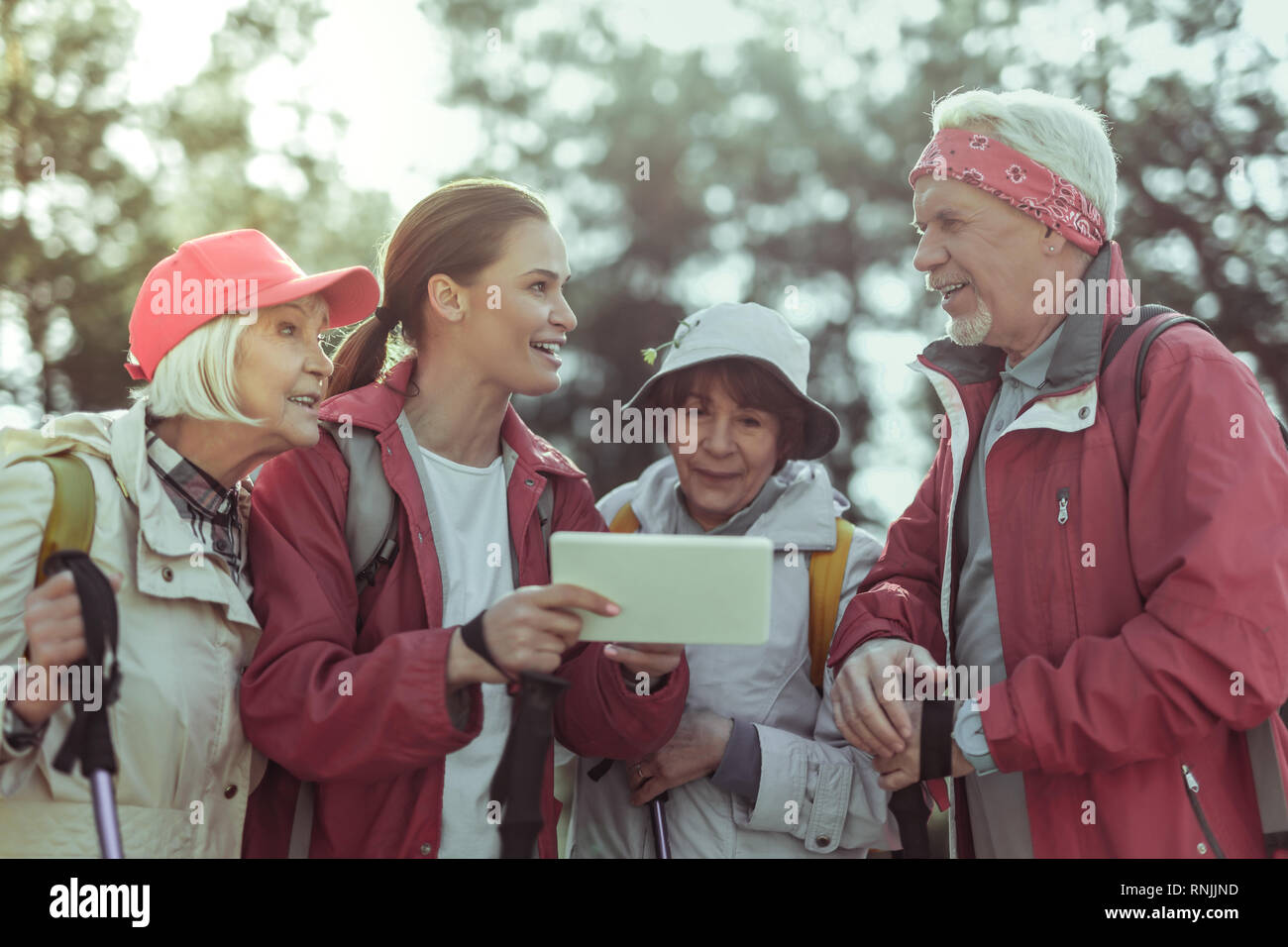 Tourists using a tablet with gps app for hiking Stock Photo