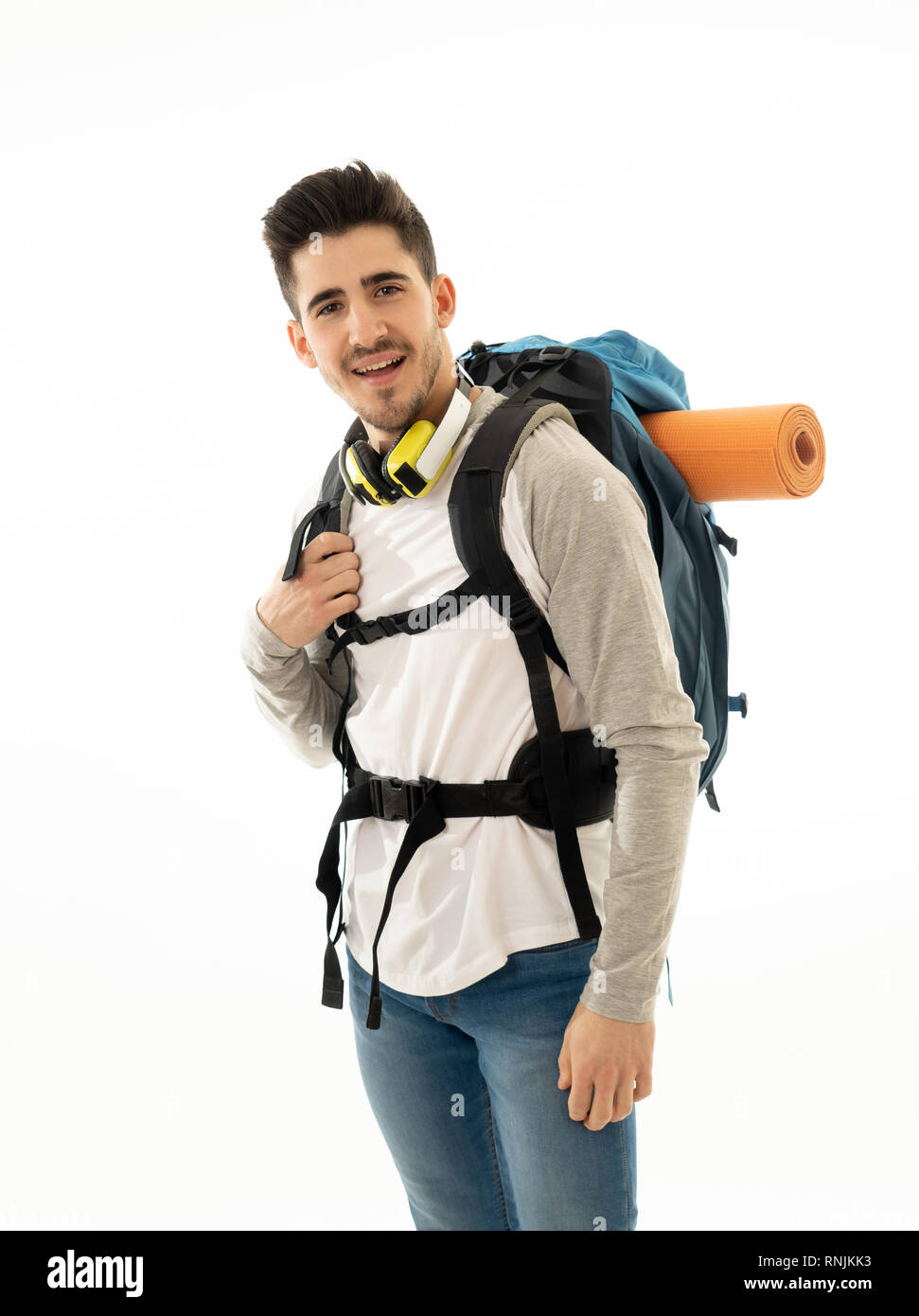 Portrait of happy cool latin man with backpack isolated on white background. In traveling the