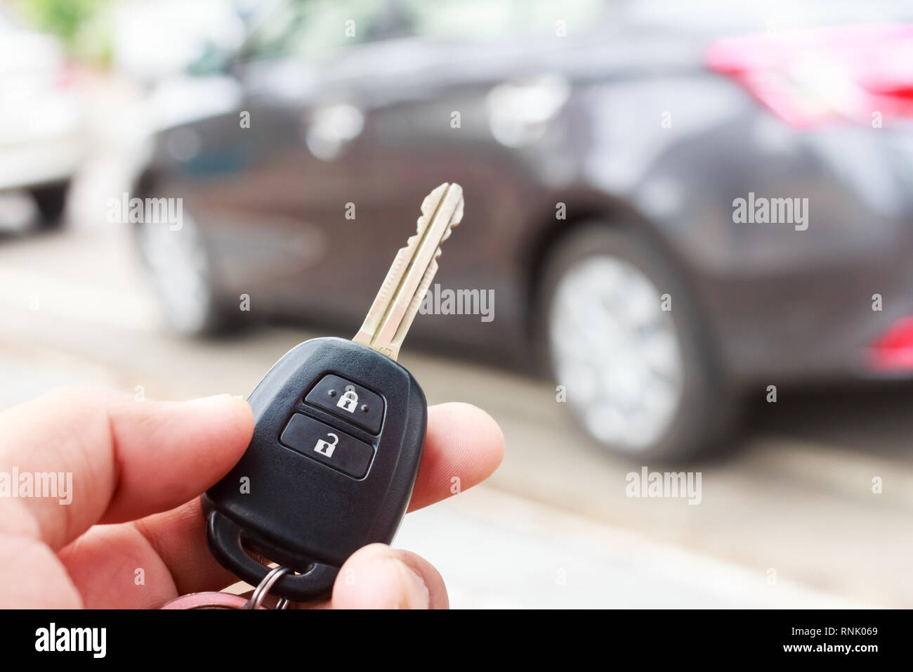 Hand presses on the remote control car alarm. Stock Photo