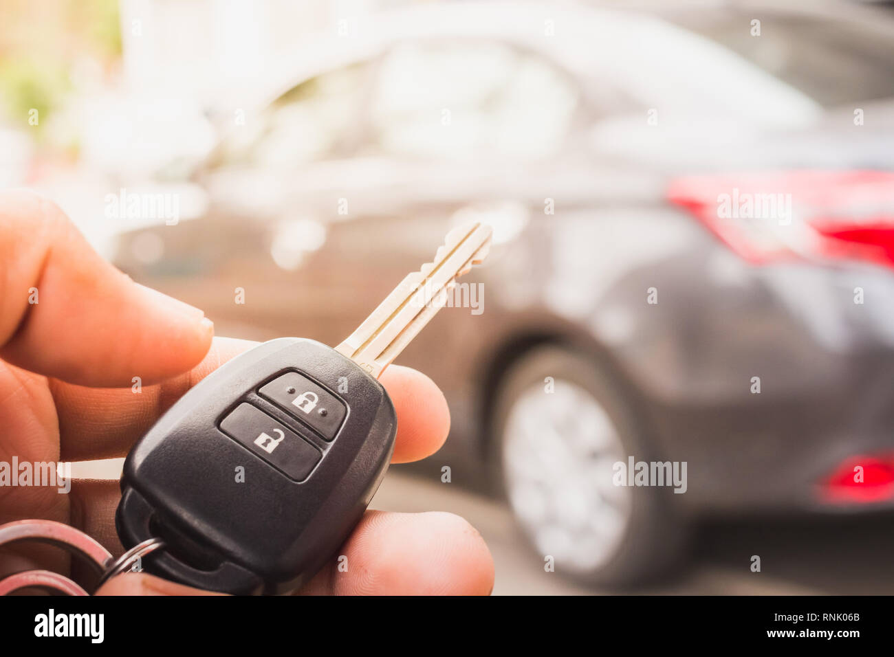 Hand presses on the remote control car alarm. Stock Photo