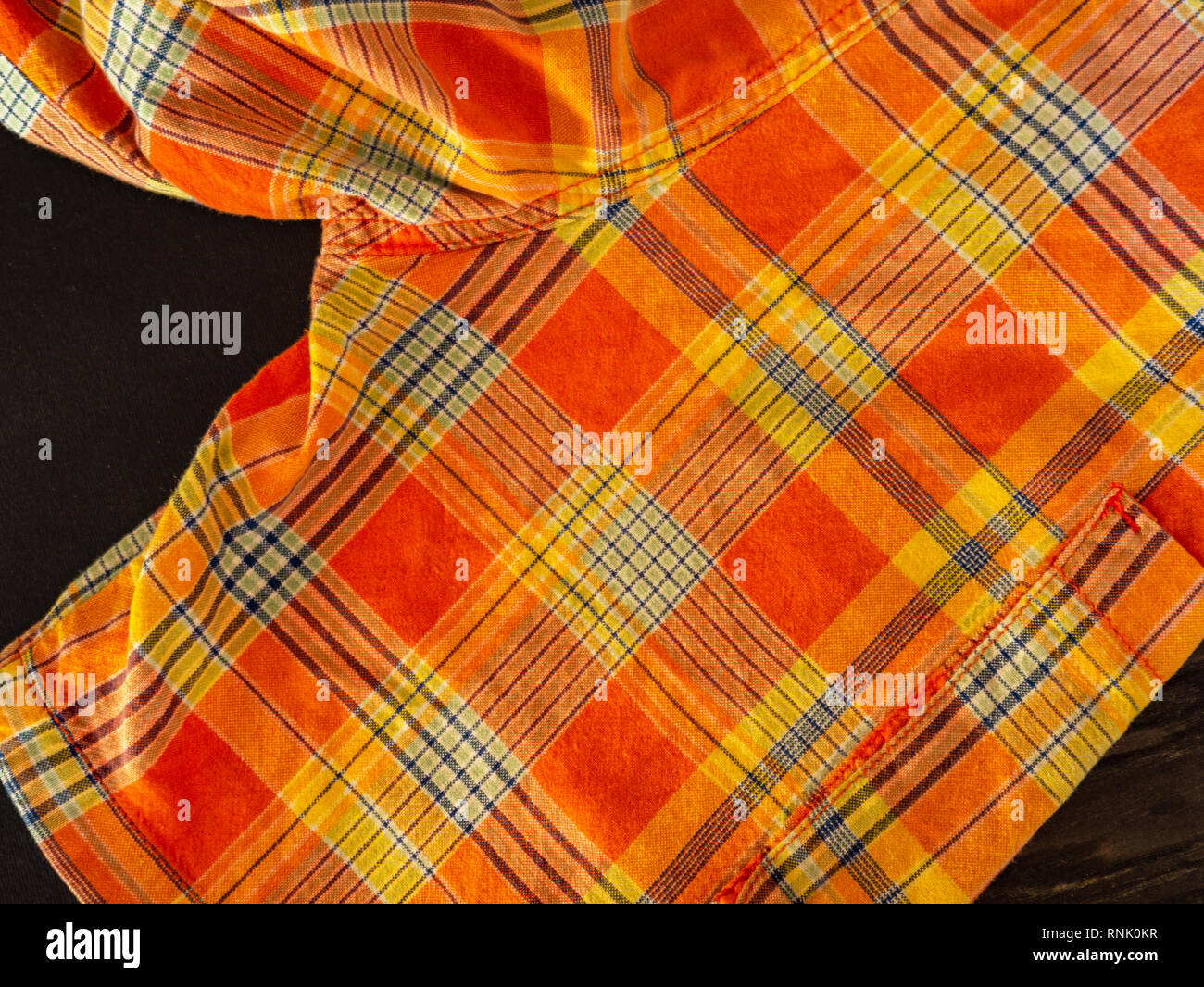Orange and yellow plaid print as background. Scottish tartan pattern. Symmetric rhombus pattern. Stock Photo