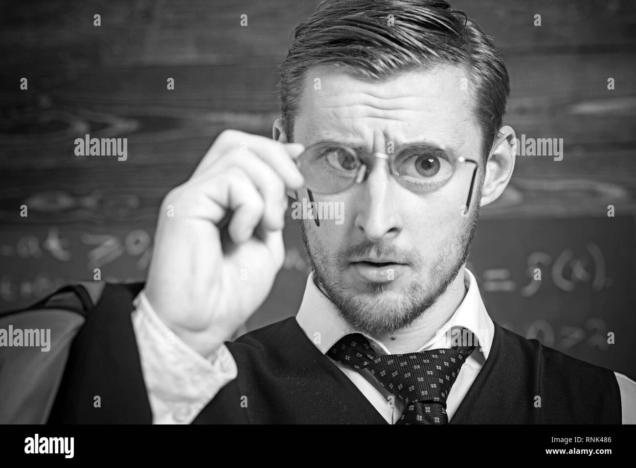 Closeup Portrait Of Blond Guy Holding Glasses With Magnifying