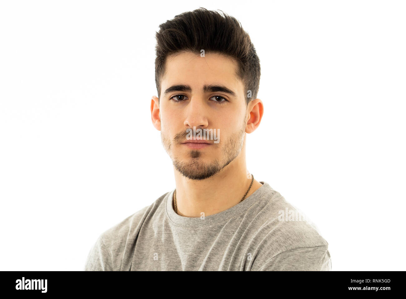 Close up portrait of attractive, confident young man looking neutral