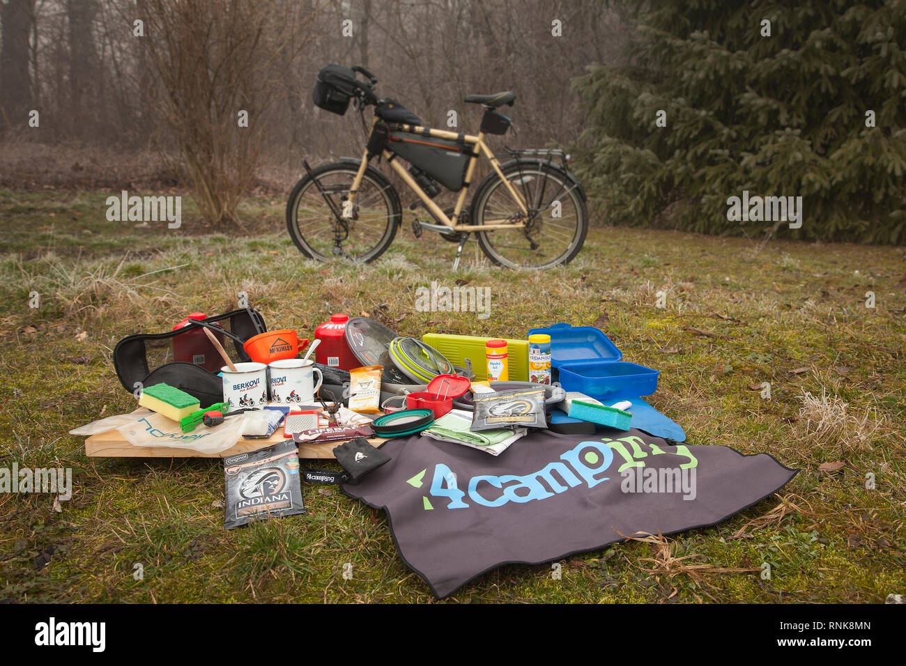 Person packing the bicycle panniers on a long cycle tour with family. A