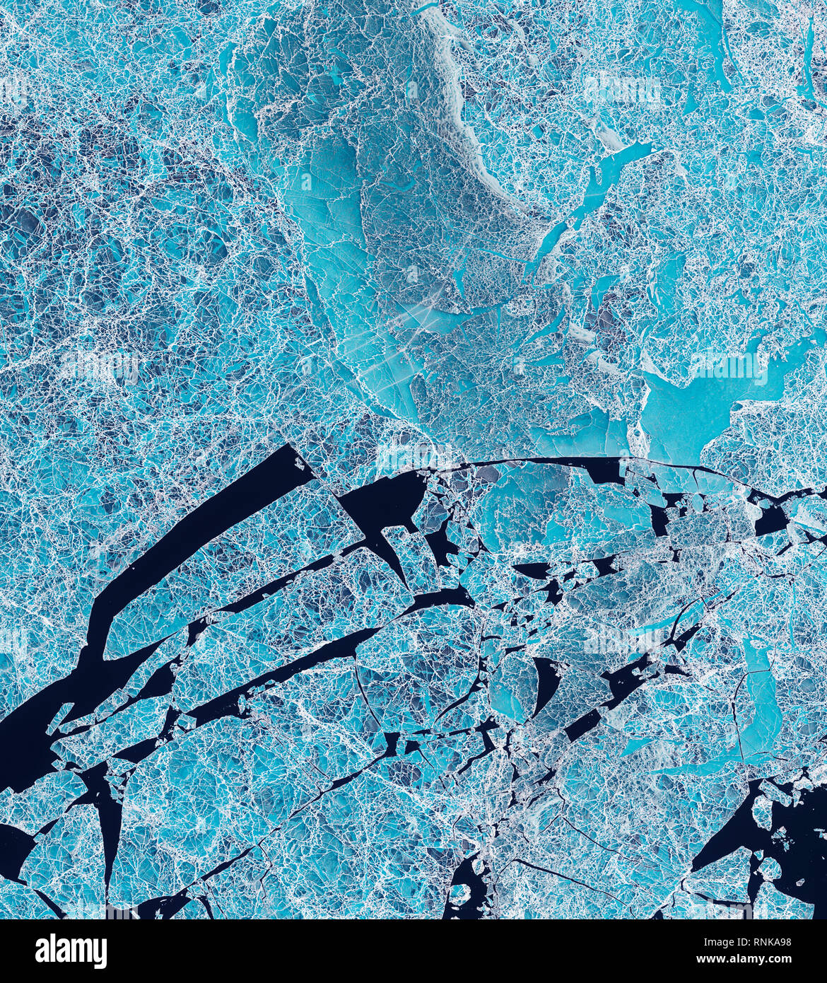 Satellite view of  the frozen Russian Sannikov Strait showing ice breaks Stock Photo