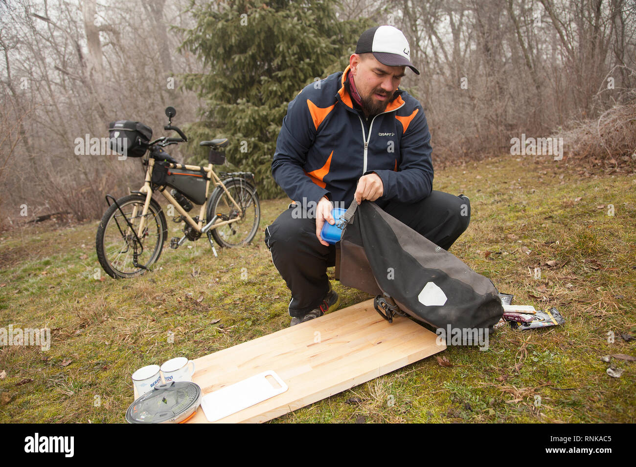 Person packing the bicycle panniers on a long cycle tour with family. A