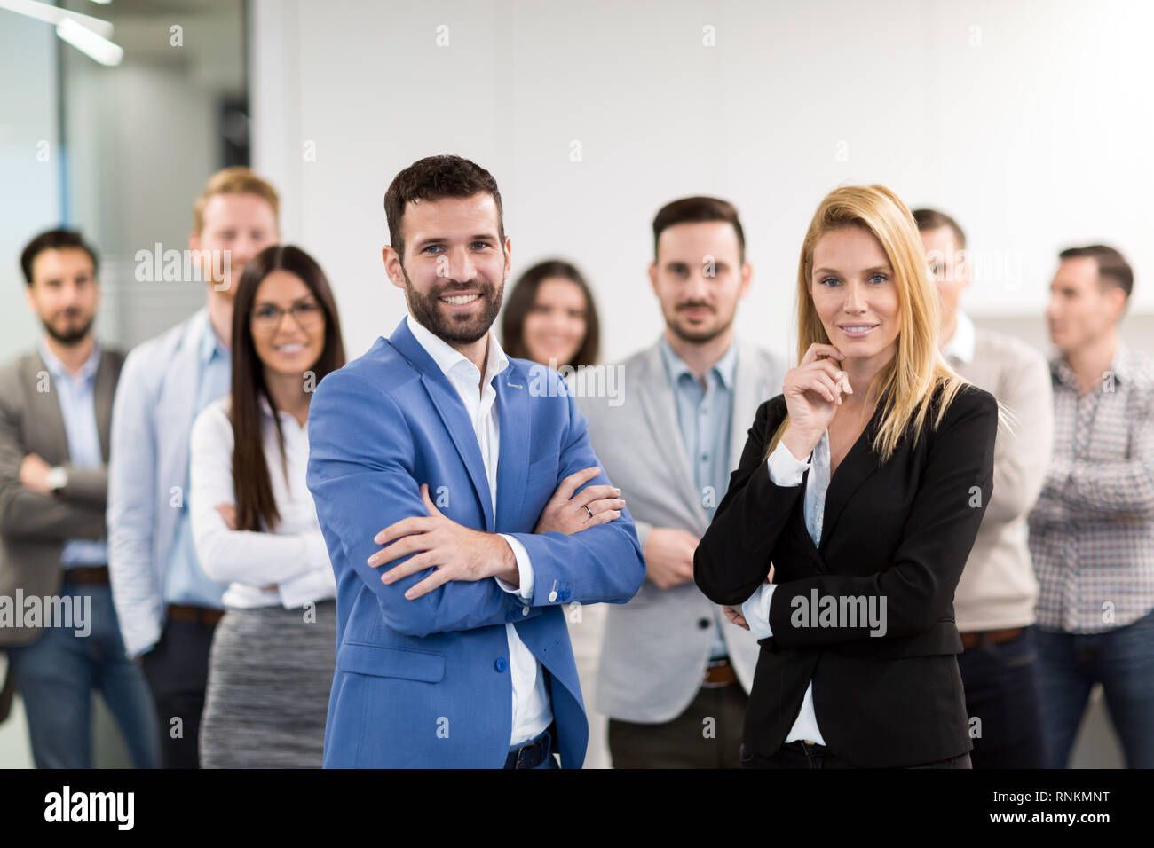Portrait of business team posing in office Stock Photo - Alamy