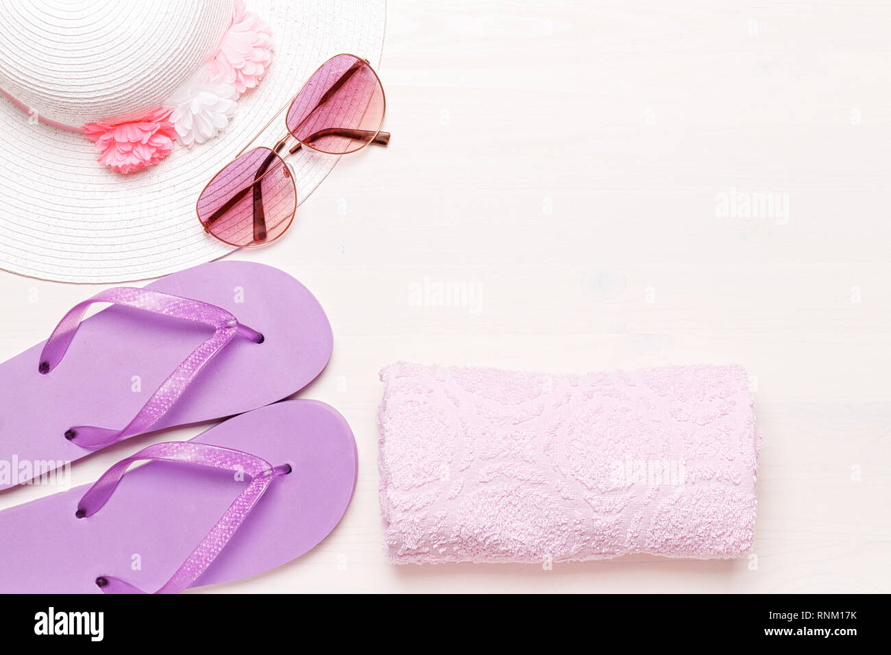 Beach accessories on a white background - sunglasses, towel, slippers and hat. summer comes concept Stock Photo