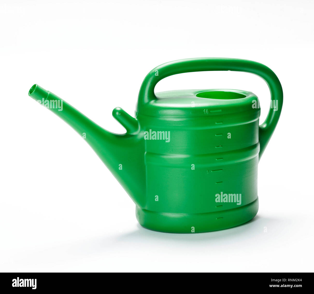 Green watering can made of plastic. Studio picture against a white background. Stock Photo