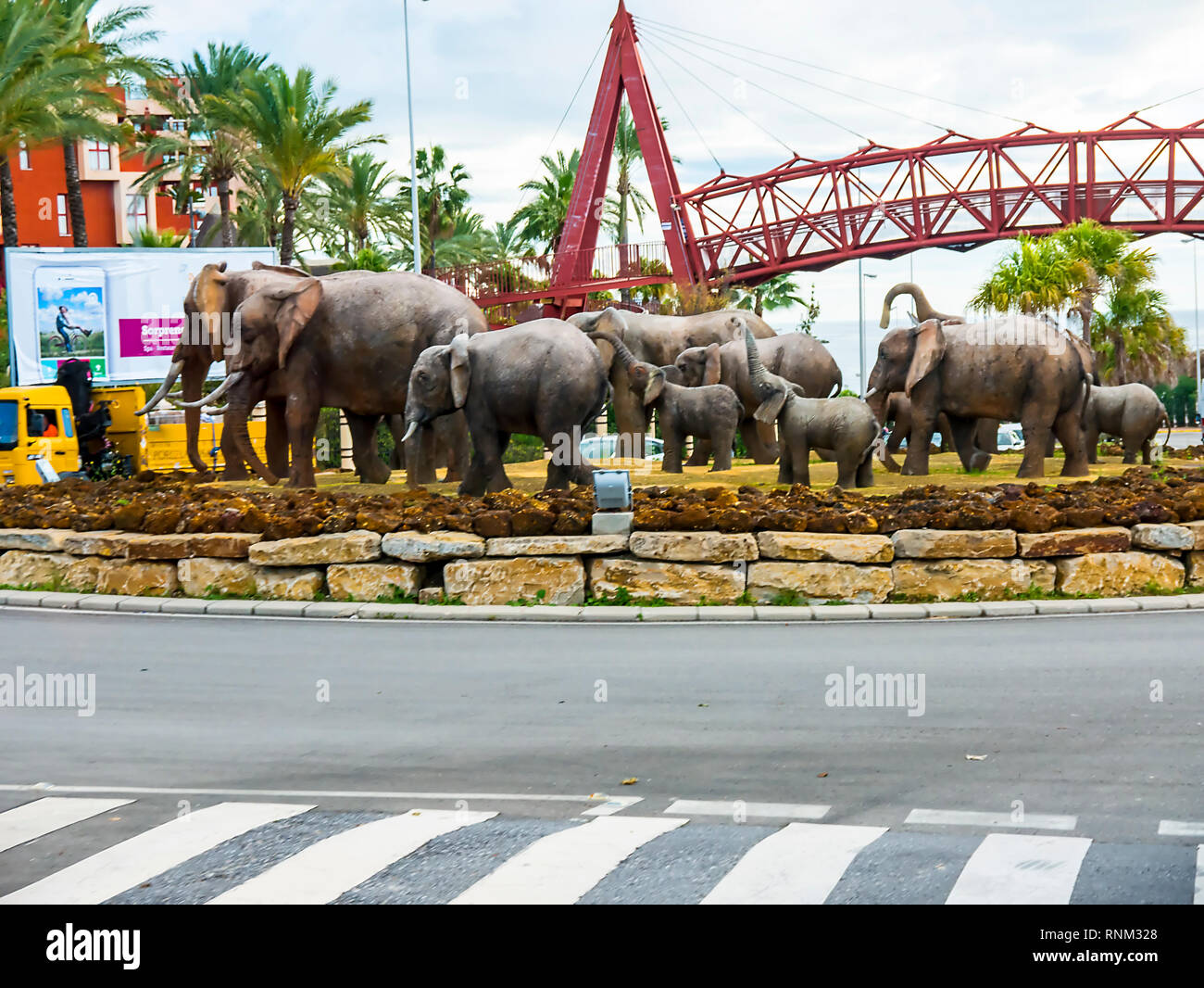 Quirky Sculpture of a herd of Elephants on a traffic Island in the