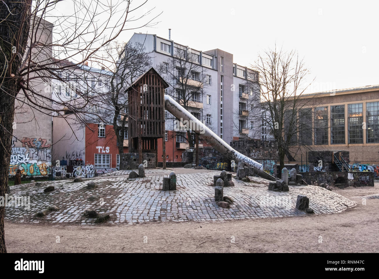 Berlin Mitte, Heinrich-Zille-Park, Long slide and stone play-castle in Children’s adventure playground in Bergstraße, Stock Photo