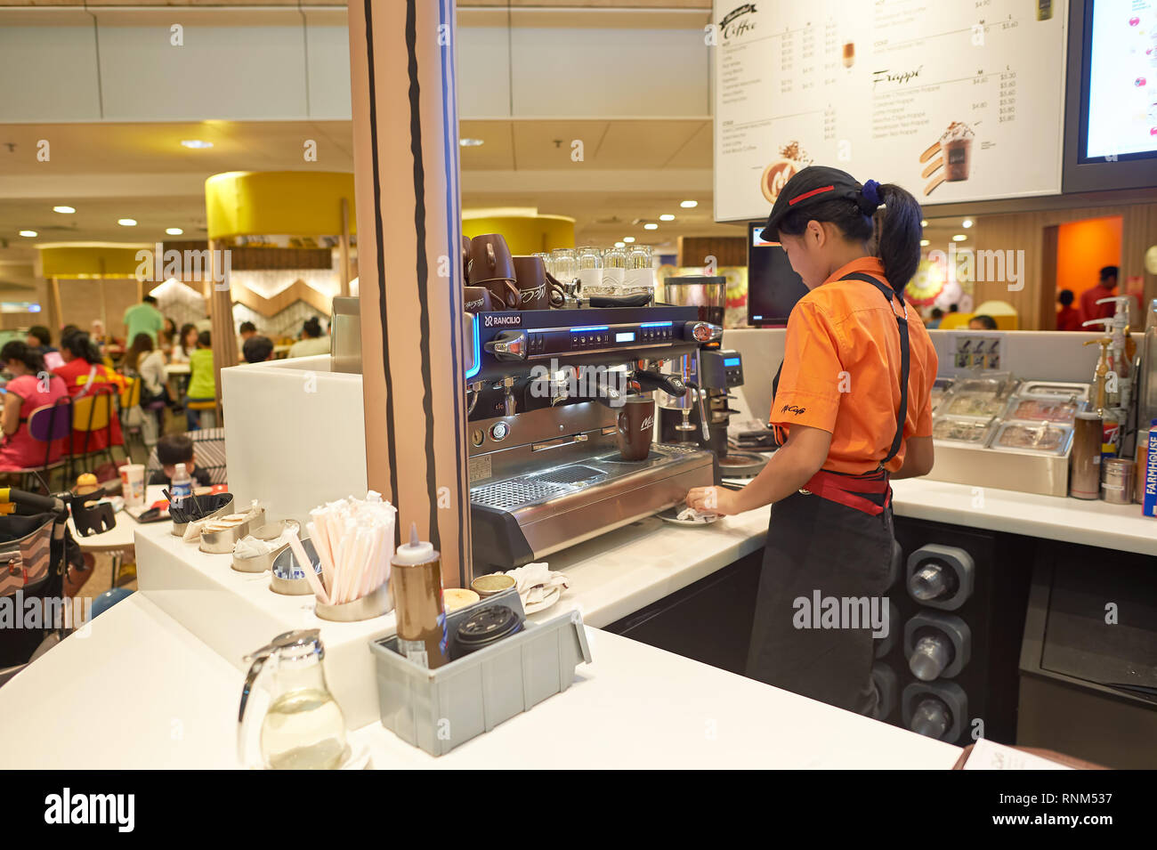 Mccafe Worker SINGAPORE - CIRCA NOVEMBER, 2015: barista in McCafe at Singapore Changi ...