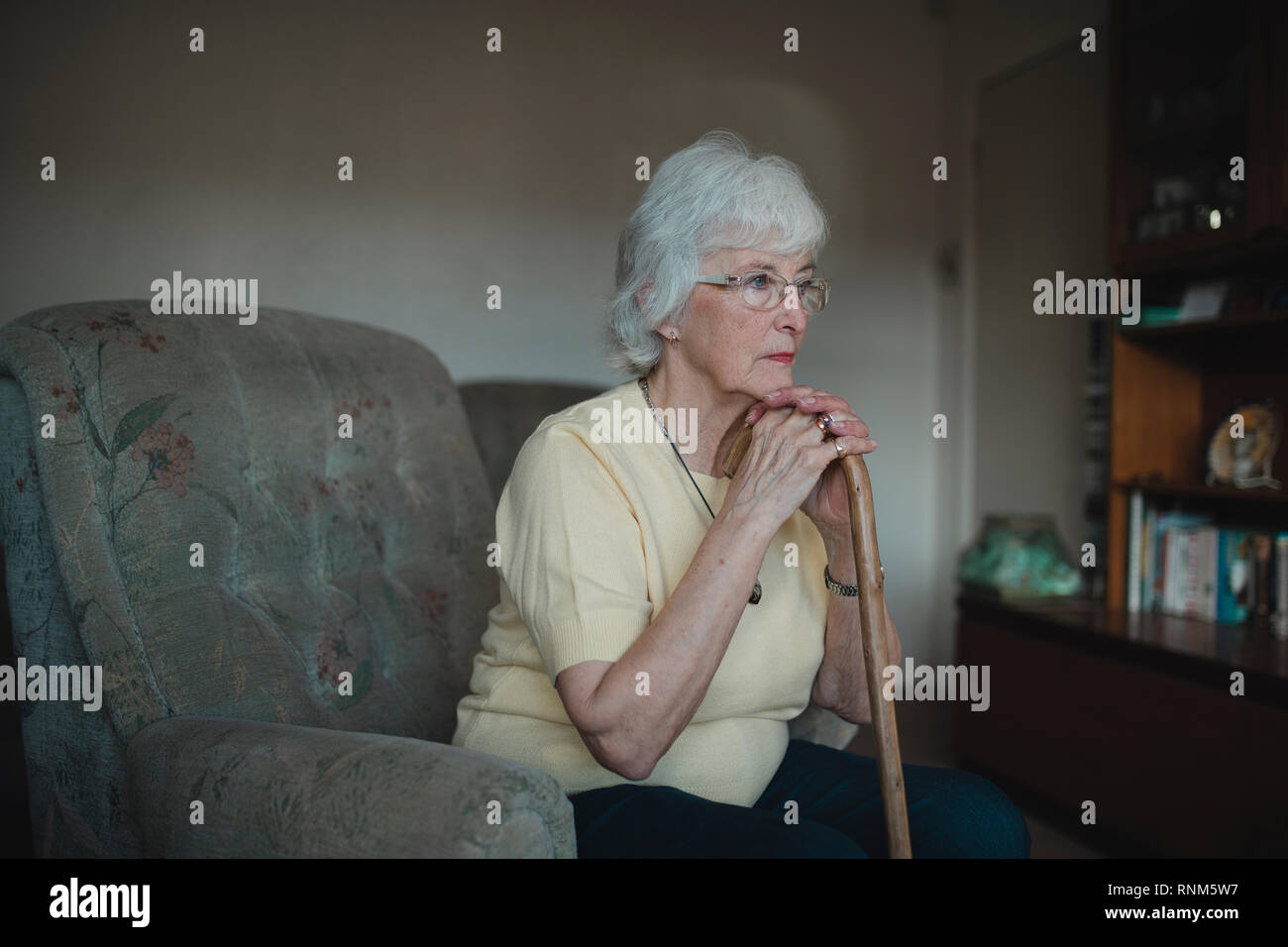 Old woman sitting alone sofa hi-res stock photography and images - Alamy