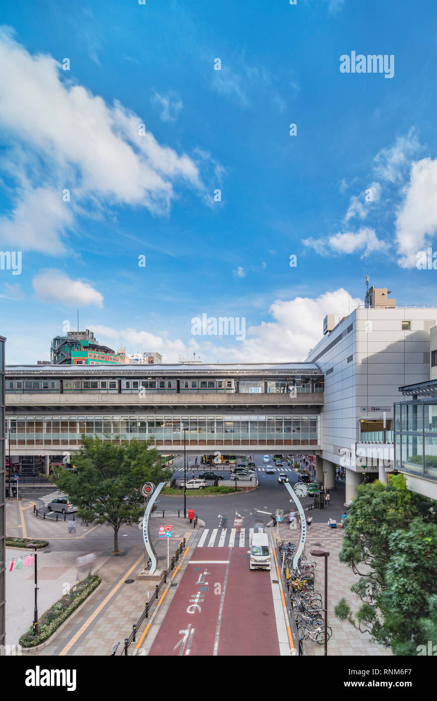 View of the square in front of the Nippori train station with the nippori friendry market arches gates, a taxi terminal and bicycle parking space in t Stock Photo