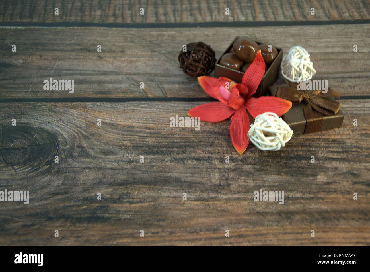 A Box Of Chocolates Decorative Balls A Bud Of Red Orchid On A