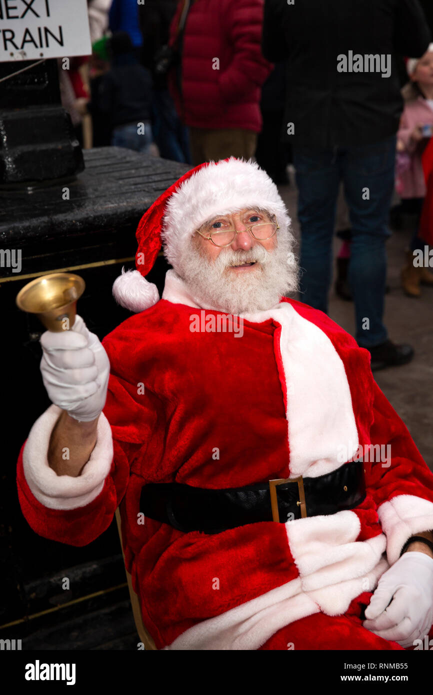 UK, England, Lancashire, Bury, East Lancashire Railway Bolton Street Station, Santa Claus ringing bell on platform Stock Photo