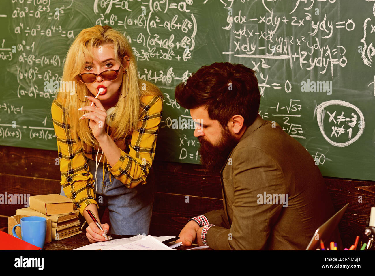 Students studying and testing lesson from teacher in classroom at ...