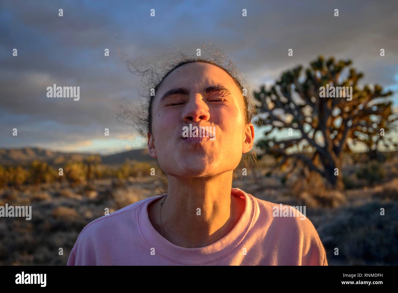 In love young pretty woman with kissing mouth, evening light, Mojave desert, desert landscape, Mojave National Preserve Stock Photo
