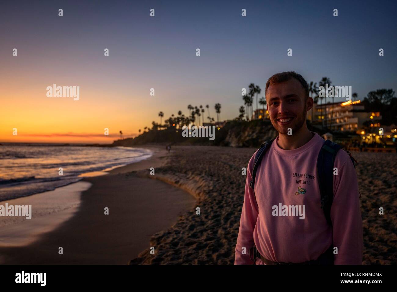 Young man at the beach at sunset, Laguna Beach, Orange County, California, USA Stock Photo