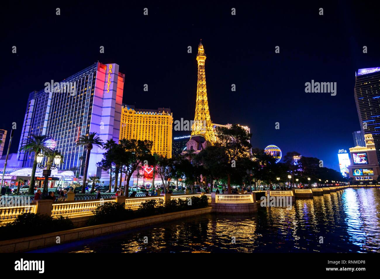 The Strip at Night, Las Vegas Strip, backlit Bally's Las Vegas and Paris Las Vegas Hotel and Casino at Night Stock Photo
