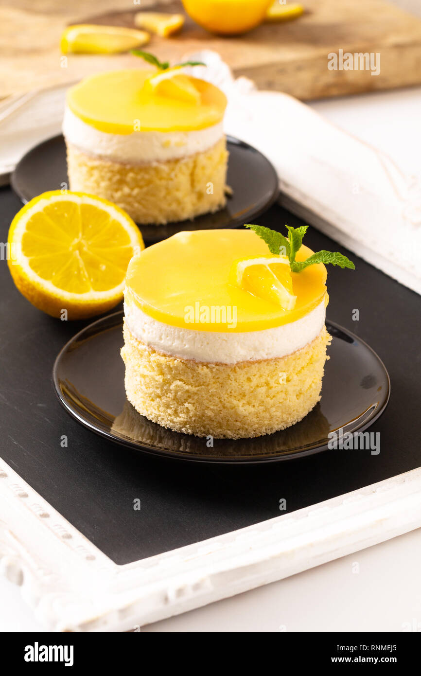 https://c8.alamy.com/comp/RNMEJ5/food-concept-homemade-lemon-curd-sponge-cake-with-fresh-whipped-cream-in-black-plate-with-copy-space-RNMEJ5.jpg