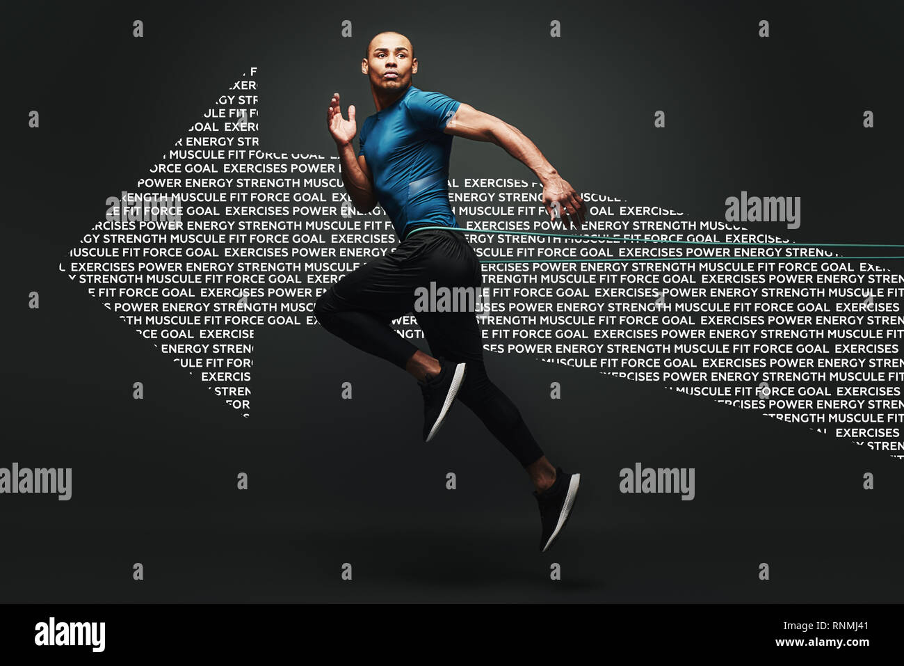 Isolated studio shot of clean shaven young dark skinned male athlete with strong muscular shoulders working out using resistance elastic band, jumping, strengthening arm muscles over dark background. Full length. Graphic drawing. Stock Photo