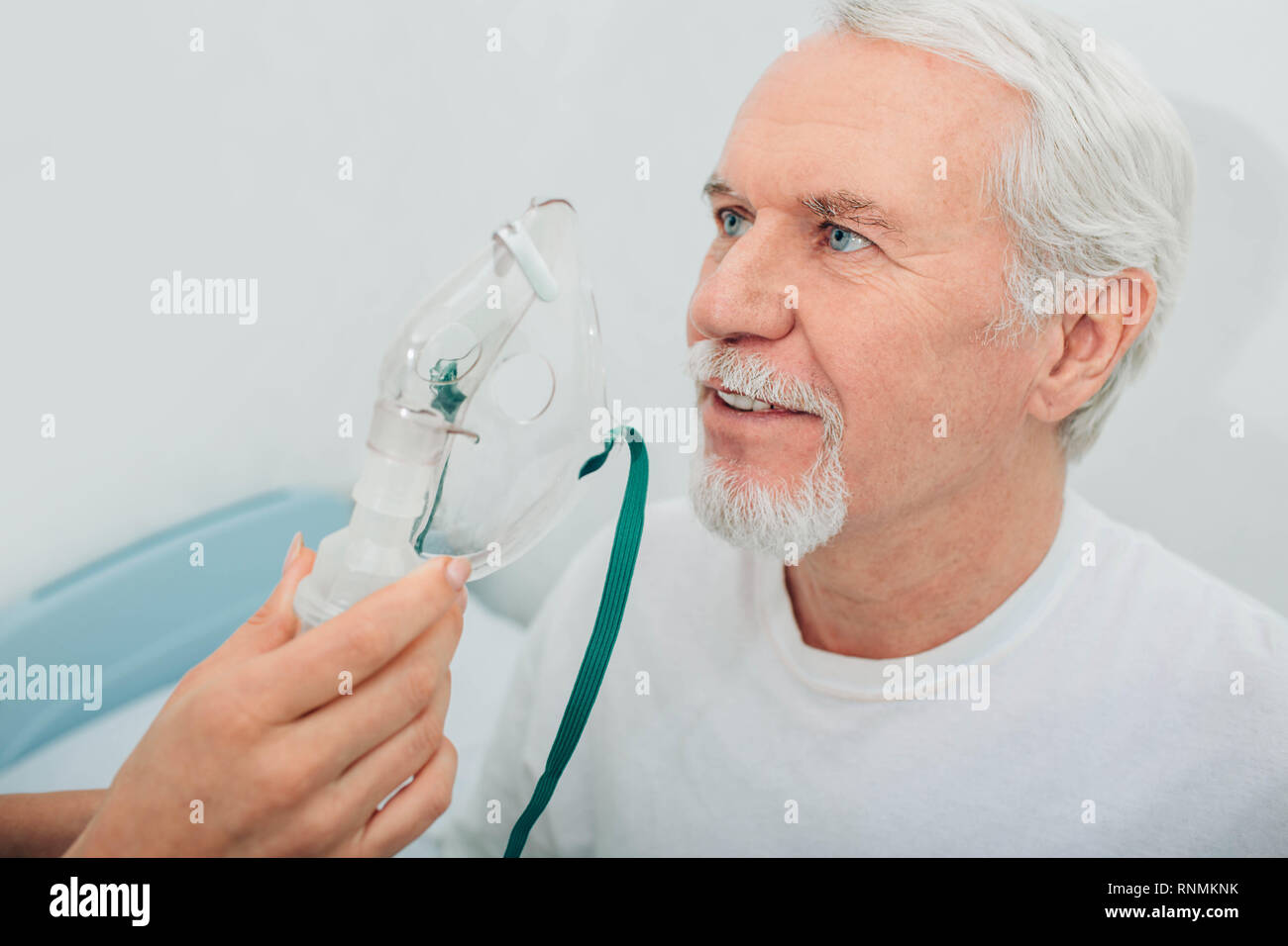 Senior man preparing to procedure inhalation at hospital Stock Photo
