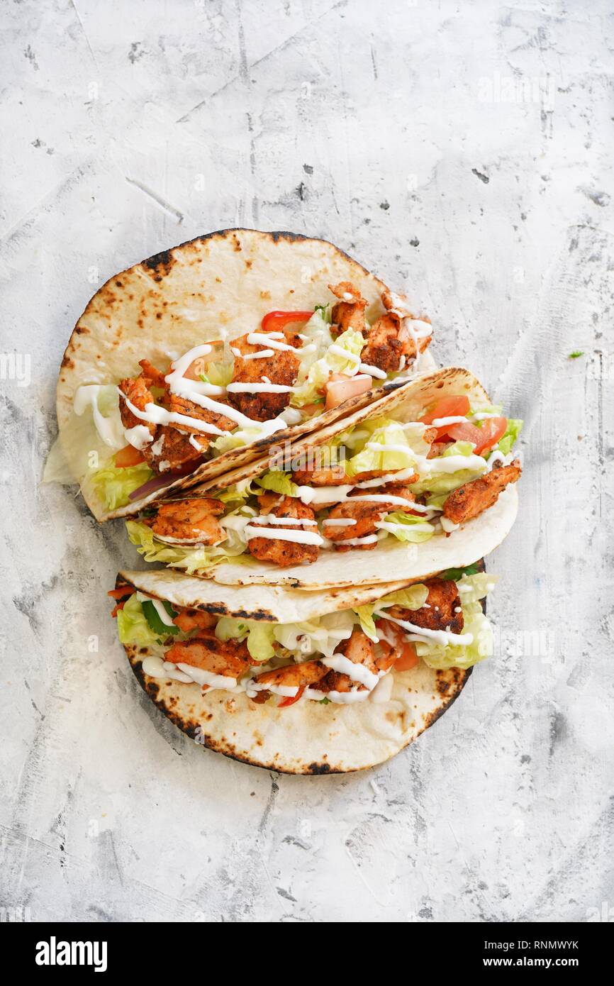 Homemade Grilled Salmon fish tacos drizzled with sour cream Stock Photo