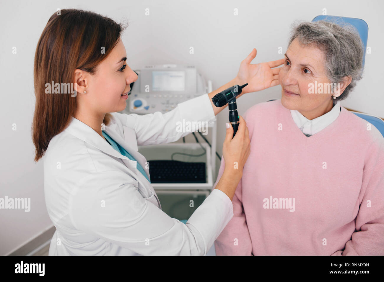 Elderly patient during an ear examination, ear exam at clinic. Stock Photo