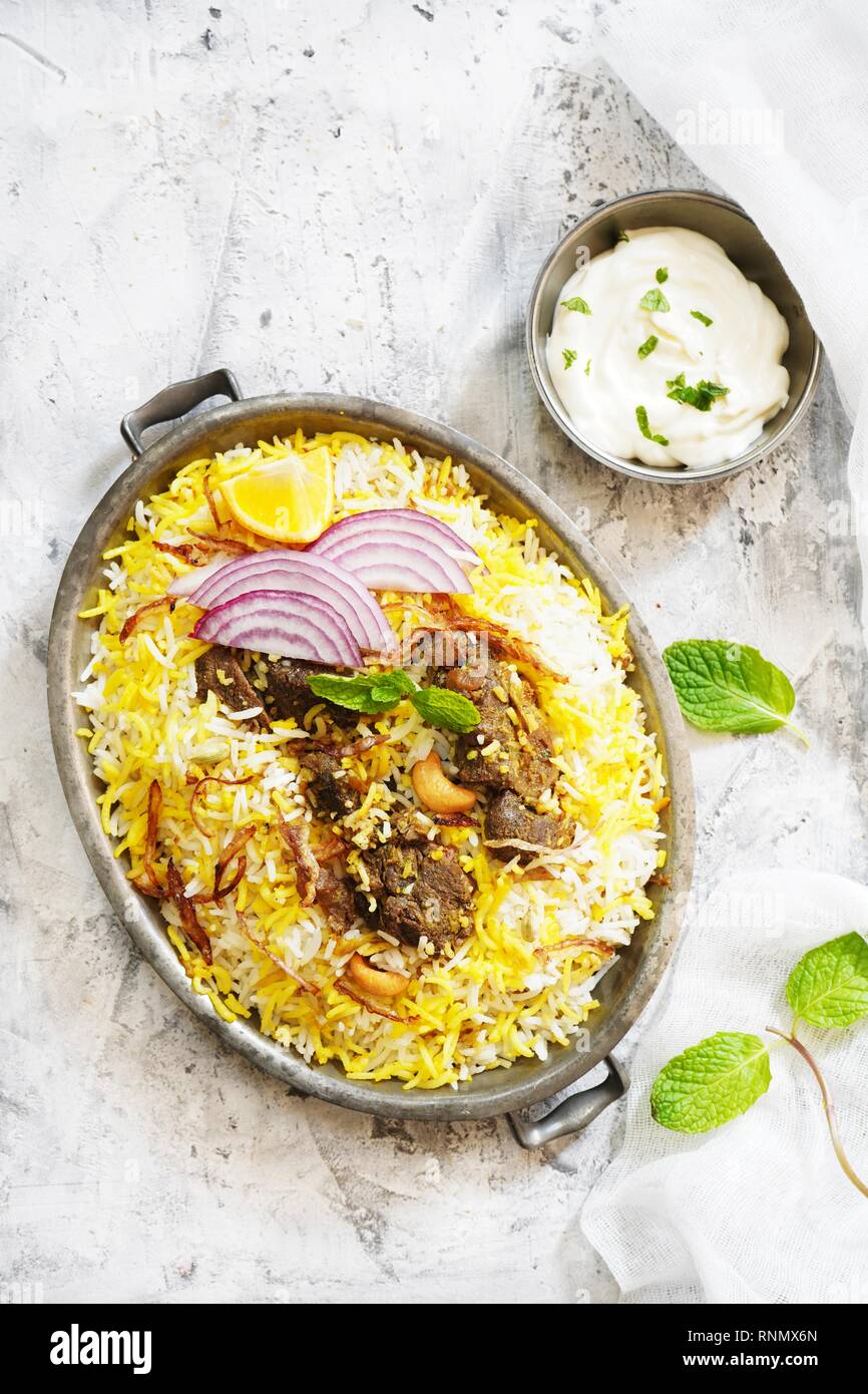 Homemade Beef Biryani served with Raita yogurt dip, overhead view Stock