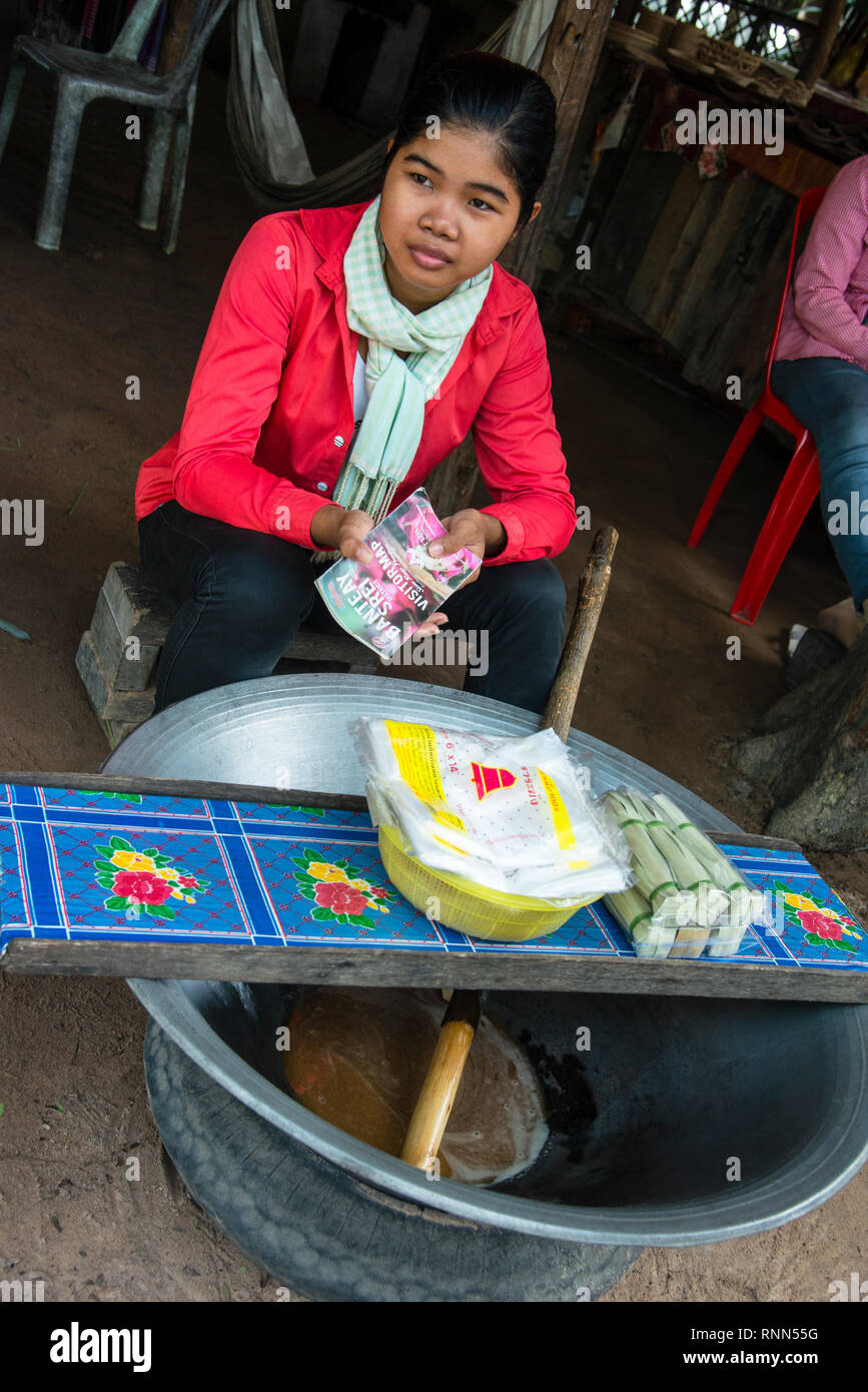 Cambodian woman boiling collected sap making palm sugar candy in a small village in Siem Reap, Cambodia. Stock Photo