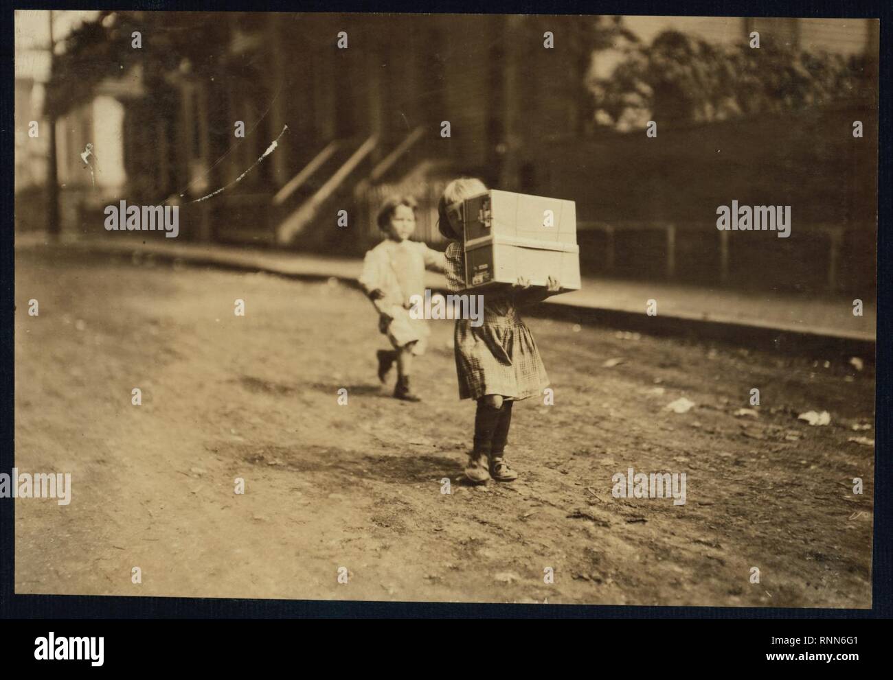 Carrying tags. A little tot with a heavy load Stock Photo Alamy