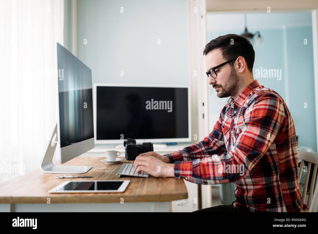 Young designer working on project at home Stock Photo