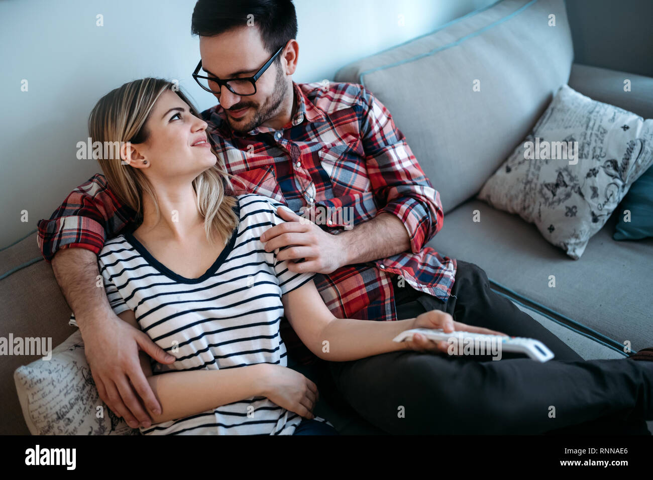 Portrait of young loving couple in living room Stock Photo
