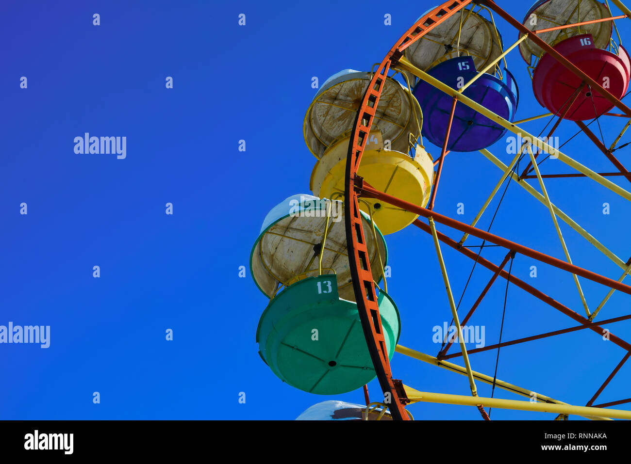 Multicolour ferris wheel on blue sky background Stock Photo - Alamy