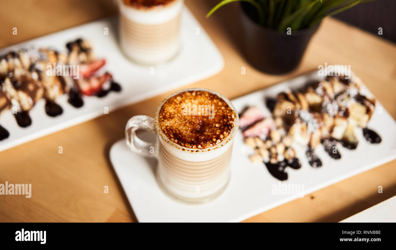 Banner Size Of Two Cups Of Hot Latte With Baked Caramel Crust And Sweet Roll With Banana And Strawberry On The Wooden Table In Coffe Shop Coffee Conc Stock Photo Alamy