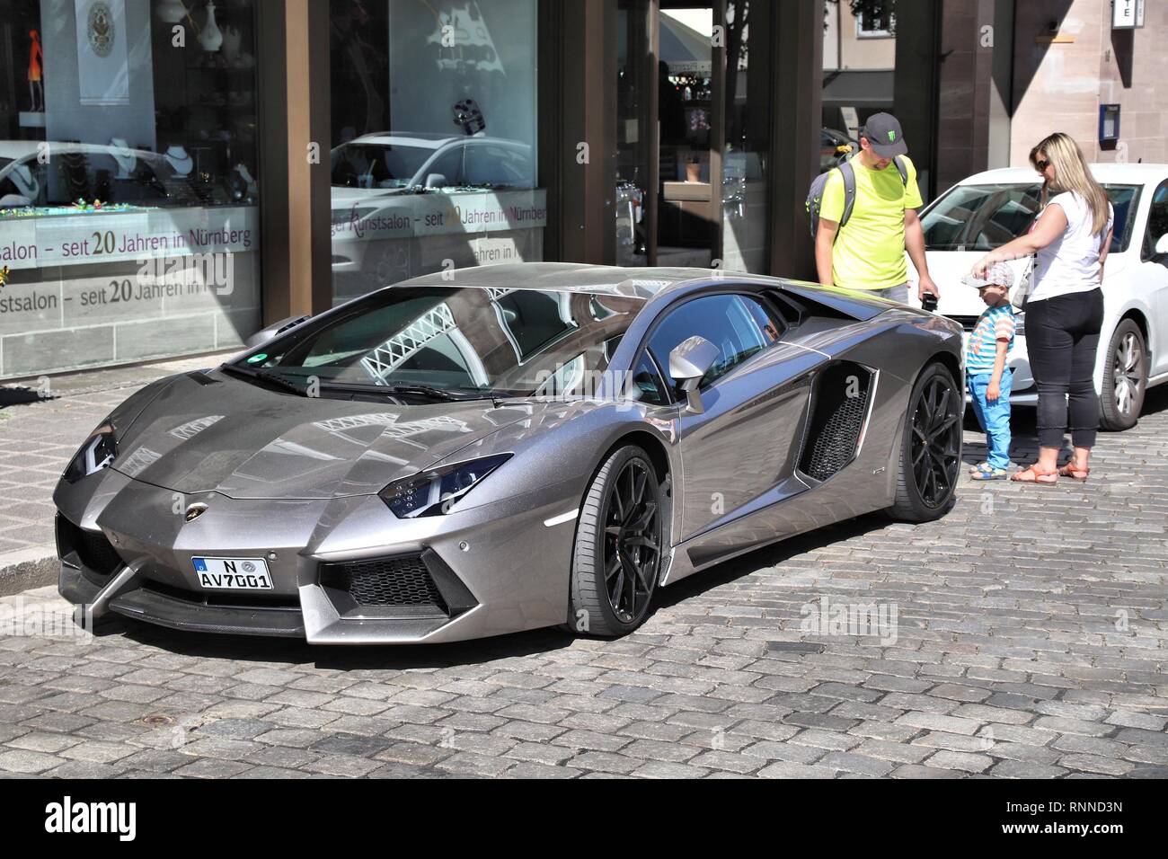 NUREMBERG, GERMANY - MAY 6, 2018: People admire Lamborghini Aventador luxury sports car parked in Germany. The car was designed by Filippo Perini. Stock Photo