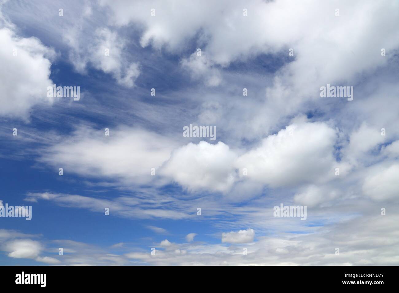 White fluffy clouds on blue hi-res stock photography and images - Alamy