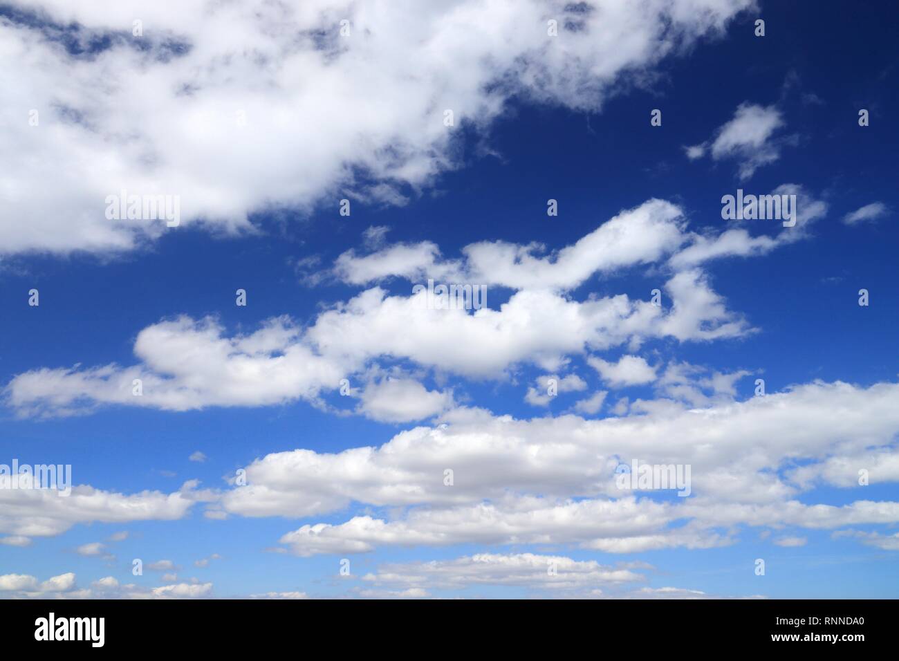 White fluffy clouds on blue hi-res stock photography and images - Alamy