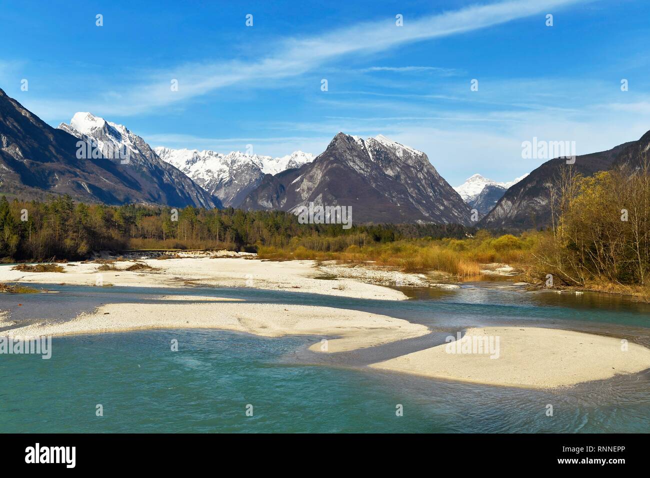 Mountain river Soca, behind snow-covered Kanin mountains, Bovec, Soca valley, Julian Alps, Slovenia Stock Photo