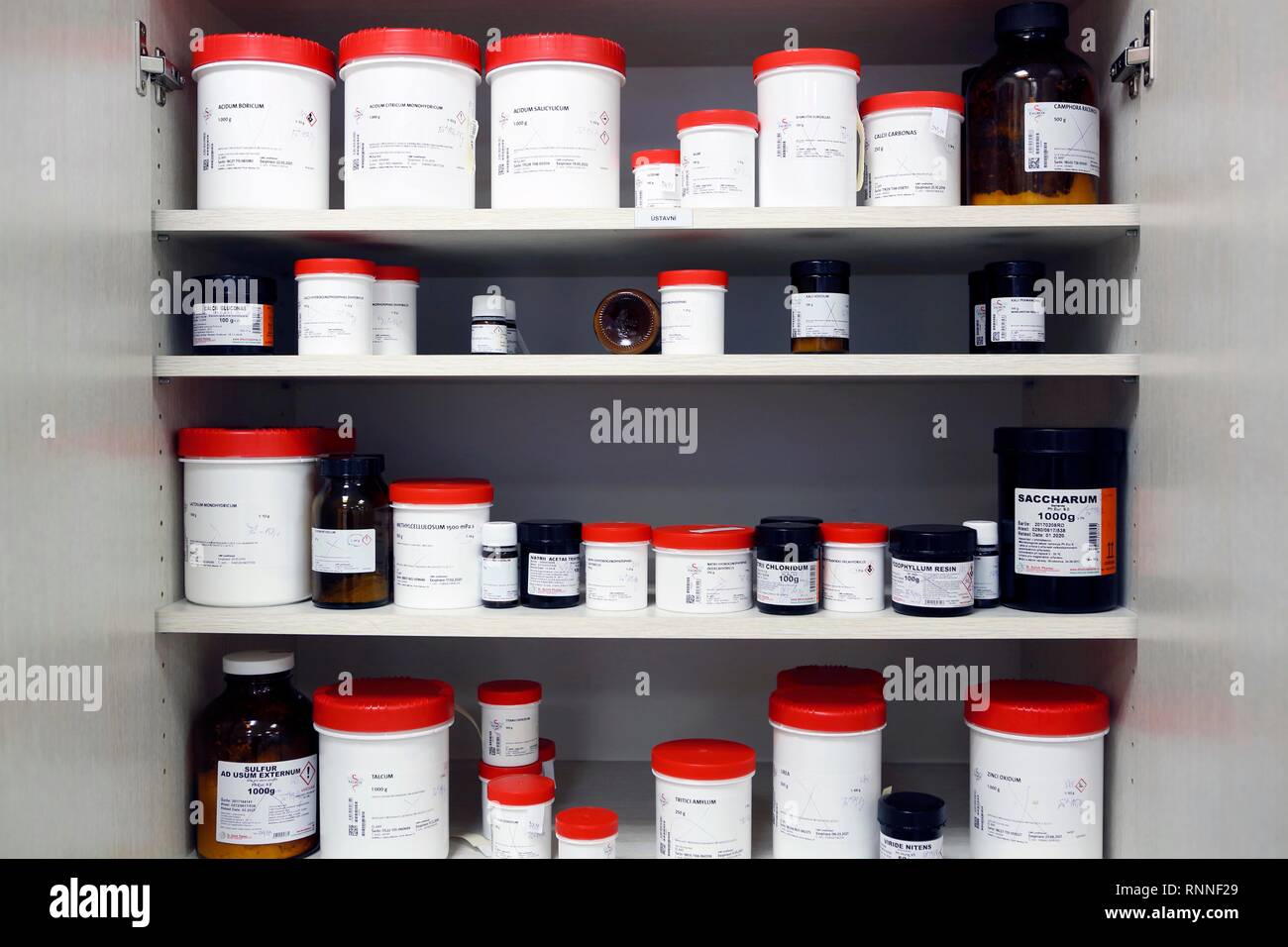 Medicines in containers in the cupboard of a pharmacy, Czech Republic Stock Photo